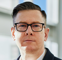 Ritratto di Alexander Hughes, CEO e dirigente di un'azienda di compravendita di criptovalute